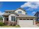 Charming two-story home with a well-manicured lawn and attached two-car garage at 9640 S Johnson St, Littleton, CO 80127