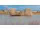 Picturesque lake view with a small island, birds, and scenic mountains in the background at 9640 S Johnson St, Littleton, CO 80127