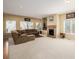 Cozy living room featuring a fireplace, plush seating, and natural light at 9640 S Johnson St, Littleton, CO 80127