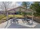Covered picnic area featuring multiple tables and surrounding green space for outdoor enjoyment at 9640 S Johnson St, Littleton, CO 80127