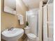 Updated bathroom features shower stall, white sink, and toilet, offering a clean and functional space at 2891 W Long Dr # D, Littleton, CO 80120