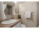 Neutral-toned bathroom featuring a sink with mirror and a walk-in shower at 2891 W Long Dr # D, Littleton, CO 80120