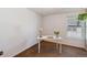 Bright bedroom featuring a sunny window and a small table with fresh flowers at 2891 W Long Dr # D, Littleton, CO 80120