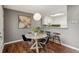 Dining area with modern table, chairs, and bar seating next to an open concept kitchen at 2891 W Long Dr # D, Littleton, CO 80120