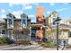 Charming exterior of a townhouse with a brick chimney, dormer windows and a front porch at 2891 W Long Dr # D, Littleton, CO 80120