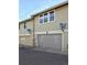 Apartment building featuring garages, satellite dishes and multiple windows at 2891 W Long Dr # D, Littleton, CO 80120