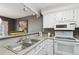 Functional kitchen with ample counter space, white appliances, and breakfast bar seating at 2891 W Long Dr # D, Littleton, CO 80120