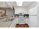 Bright, functional kitchen featuring white appliances, ample counter space, and modern lighting at 2891 W Long Dr # D, Littleton, CO 80120