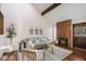 Bright living room with vaulted ceiling, brick fireplace, wood floors and modern furnishings at 2891 W Long Dr # D, Littleton, CO 80120
