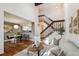 Inviting living space featuring an open floor plan, staircase, hardwood floors, and dining area at 2891 W Long Dr # D, Littleton, CO 80120