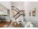 Open-concept living area with a wooden staircase, hardwood floors, and a modern aesthetic at 2891 W Long Dr # D, Littleton, CO 80120