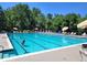 Community pool with crystal-clear water, lounge chairs, and umbrellas, ideal for summer relaxation at 2891 W Long Dr # D, Littleton, CO 80120