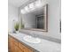 Bright bathroom with granite countertop, updated vanity, and a large mirror at 3656 S Depew St # 104, Denver, CO 80235