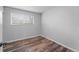 Well-lit bedroom featuring wood-look flooring and a window at 3656 S Depew St # 104, Denver, CO 80235
