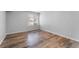 Simple bedroom with wood-look floors and a window with blinds at 3656 S Depew St # 104, Denver, CO 80235