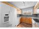 White appliances and light wood cabinets in kitchen at 3656 S Depew St # 104, Denver, CO 80235