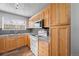 Kitchen with wood cabinets, granite countertops at 3656 S Depew St # 104, Denver, CO 80235