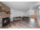 Living room with stone fireplace and hardwood floors at 3656 S Depew St # 104, Denver, CO 80235