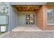 Private patio with sliding glass doors and brick wall at 3656 S Depew St # 104, Denver, CO 80235