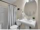 Cozy bathroom featuring a pedestal sink, toilet, and shower-tub combination at 312 Allen St, Golden, CO 80401
