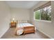 Bright bedroom with a side table, lamp, and window allowing natural light to filter in at 312 Allen St, Golden, CO 80401