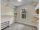Walk-in closet featuring clothing racks, shelves, and a window for natural light at 312 Allen St, Golden, CO 80401