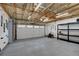 Bright, spacious garage with concrete floor, overhead lighting, and storage shelves at 312 Allen St, Golden, CO 80401
