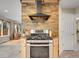 Contemporary kitchen with stainless steel range and hood set against a stylish stone accent wall at 312 Allen St, Golden, CO 80401