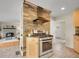 A stylish kitchen with stainless steel range and hood, complemented by a beautiful stone backsplash at 312 Allen St, Golden, CO 80401