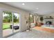 Bright sunroom with hardwood floors, a brick fireplace, and large sliding doors to a private backyard patio at 312 Allen St, Golden, CO 80401