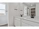 Bathroom features dual sinks with modern fixtures, white cabinetry, and quartz countertop at 3464 N Irvington St, Aurora, CO 80019