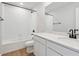 Well-lit bathroom showcases a tub, white cabinets and stylish black fixtures at 3464 N Irvington St, Aurora, CO 80019