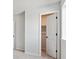 Neutral bedroom with door ajar leading to a walk-in closet, showcasing ample storage space at 3464 N Irvington St, Aurora, CO 80019