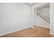 Hallway with hardwood floors leads to staircase with white banister at 3464 N Irvington St, Aurora, CO 80019