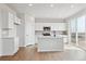 Bright kitchen features white cabinetry, stainless appliances, and island with countertop space at 3464 N Irvington St, Aurora, CO 80019