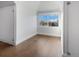 Well-lit empty room with hardwood floors, fresh paint and a large window at 756 Kalamath St, Denver, CO 80204