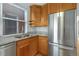 Modern kitchen with stainless steel appliances, granite countertops, and natural wood cabinets at 756 Kalamath St, Denver, CO 80204