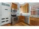 Well-lit kitchen featuring stainless steel appliances, light wood cabinets, and granite countertops at 756 Kalamath St, Denver, CO 80204