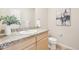 Stylish bathroom featuring granite countertops, artwork, and light wood cabinets at 3101 Blake St # 309, Denver, CO 80205