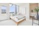 Bright bedroom with a large window, walk-in closet, and modern decor at 3101 Blake St # 309, Denver, CO 80205