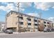 Exterior view of a multi-story condo building with balconies and street parking at 3101 Blake St # 309, Denver, CO 80205