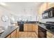 Modern kitchen with wood cabinets, stainless steel appliances, and granite countertops at 3101 Blake St # 309, Denver, CO 80205