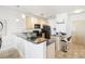 Open kitchen featuring light wood cabinets, black appliances, and a breakfast bar at 3101 Blake St # 309, Denver, CO 80205