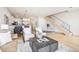Bright living space features hardwood floors, comfortable seating, and an open staircase at 3101 Blake St # 309, Denver, CO 80205