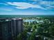 Breathtaking aerial view of a lush park, tranquil lake, and the city skyline with apartments on the side at 460 S Marion Pkwy # 453, Denver, CO 80209
