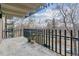 Private balcony with metal railings overlooking a landscaped view of trees and a neighborhood street at 460 S Marion Pkwy # 453, Denver, CO 80209
