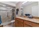 Bathroom with a tiled walk-in shower, granite countertop vanity, and a large mirror at 460 S Marion Pkwy # 453, Denver, CO 80209