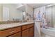 Bathroom with a tub and shower, granite countertops, and a large mirror at 460 S Marion Pkwy # 453, Denver, CO 80209