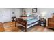 Well-lit bedroom with hardwood floors, a bed with decorative pillows, and classic furniture at 460 S Marion Pkwy # 453, Denver, CO 80209