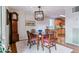 Dining room with a table and seating, a view to the kitchen, and a large grandfather clock at 460 S Marion Pkwy # 453, Denver, CO 80209